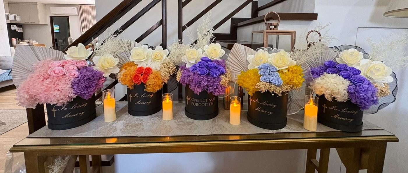Five bouquets in a row on a console table