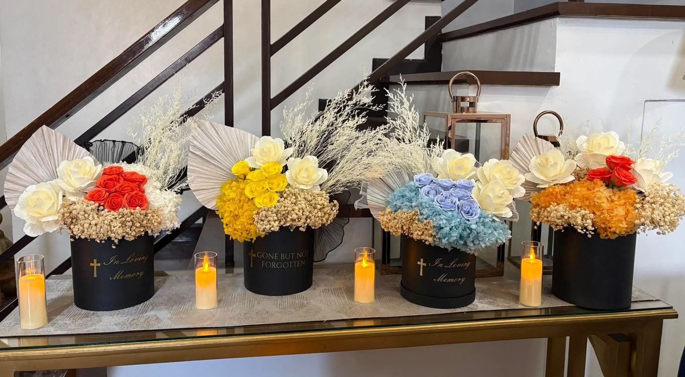 Four bouquets in a row on a console table